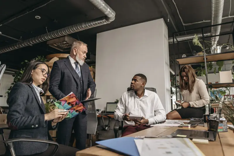 Colleagues reviewing records together at a meeting table